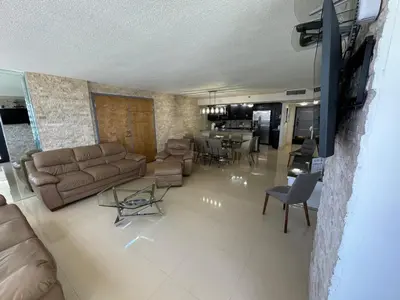 a living room with a couch and a dining room at Alexander 81921 in Miami Beach