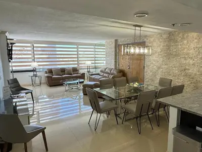 a living room with a table and a couch at Alexander 81921 in Miami Beach