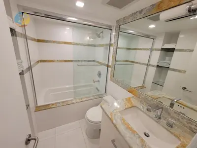 a bathroom with a shower and a toilet and a sink at Alexander 901 in Miami Beach