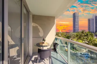 a balcony with a table and a view of the city at Apartment 2BR 2BTH - Free Parking in Sunny Isles Beach