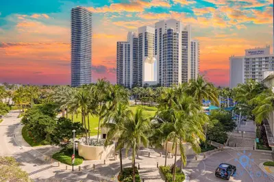 a city skyline with tall buildings and palm trees at Apartment 2BR 2BTH - Free Parking in Sunny Isles Beach