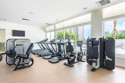 a gym with treadmills and elliptical machines at Tiffany Tides - Resort-Style Beach Townhome - Gym, Rooftop Pool and Sauna in Fort Lauderdale