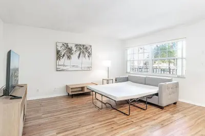 a living room with a table and a couch at Serenity Homes in Fort Lauderdale