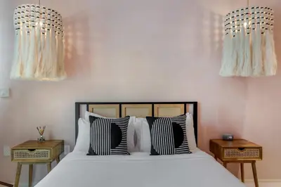 a bedroom with a bed with black and white pillows at Artisan Studio- Breakfast Nook by Design District in Miami