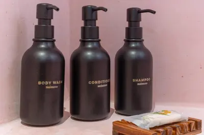 a group of three black bottles on a table at Artisan Studio- Breakfast Nook by Design District in Miami