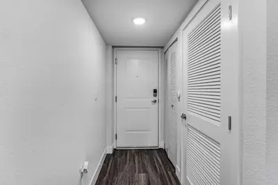 a hallway with a white door and a white wall at Stylish 1BR Unit With Free Parking Near Wynwood in Miami