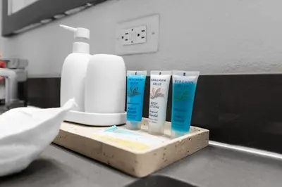 a group of three bottles of sunscreen on a counter at Sunny 1BR Unit With Free Parking Prime Location in Miami