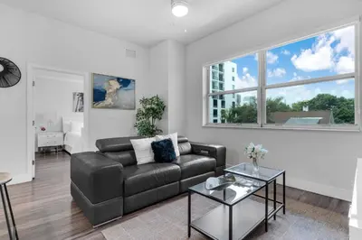 a living room with a couch and a table at Sunny 1BR Unit With Free Parking Prime Location in Miami