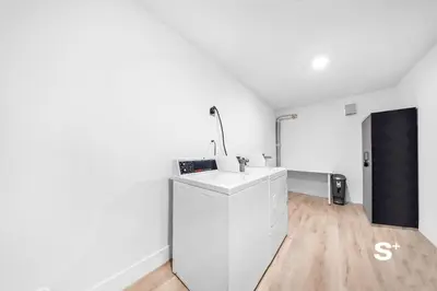 a white kitchen with a sink in a room at Chic Miami Studio - Gym, BBQ, Free Parking in Miami