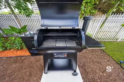 a bbq grill sitting in a yard at Stylish Studio - Parking & Gym Near Aventura in Miami
