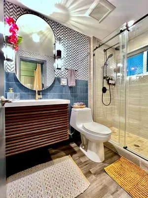 a bathroom with a toilet and a sink and a shower at Double Rainbow Suites 24th in Fort Lauderdale