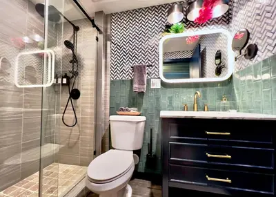 a bathroom with a toilet and a sink and a shower at Double Rainbow Suites 24th in Fort Lauderdale