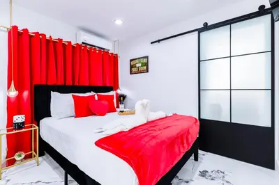 a bedroom with red curtains and a large bed at Havana Casino in Miami