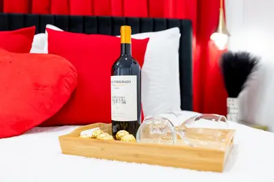 a bottle of wine on a tray on a bed at Havana Casino in Miami