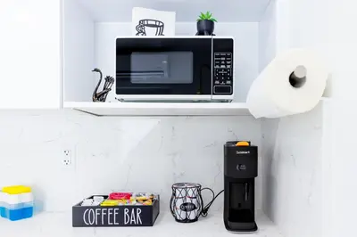 a microwave on a shelf above a coffee bar at Havana Casino in Miami