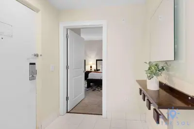a hallway with a door leading to a bedroom at Stylish Apartment 1BR - 2BTH in Miami