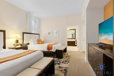 a hotel room with two beds and a flat screen tv at Stylish Apartment 1BR - 2BTH in Miami