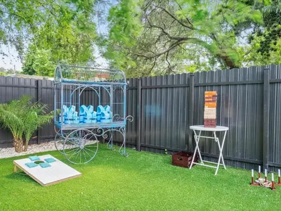 a blue bird cage in a yard next to a fence at Hidden Gem Studio Near Wynwood & Beaches in Miami