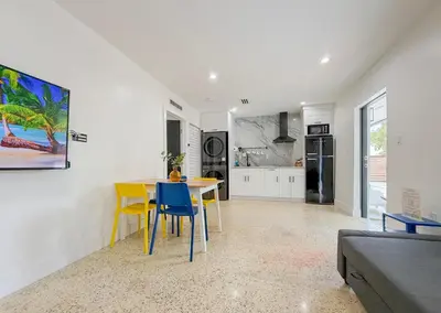 a kitchen and dining room with a table and chairs at Designer 1BR Retreat Heart of Miami Pool in Miami