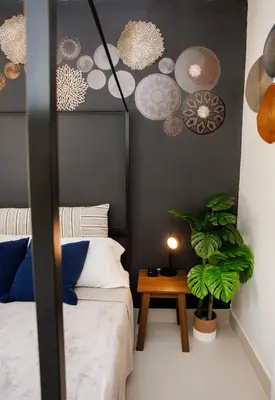 a bedroom with two beds and a table with a plant at Boho Oasis 2 in Homestead