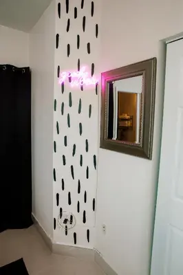 a wall with a mirror in a room at Boho Oasis 2 in Homestead