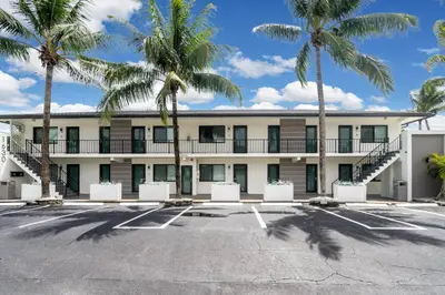 a building with palm trees in a parking lot at Rent in Fort Lauderdale near Broward Medical in Fort Lauderdale