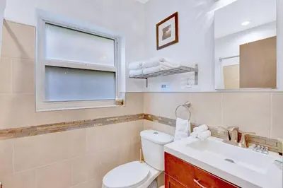 a bathroom with a toilet and a sink and a window at 320-1 Las Olas Boulevard in Fort Lauderdale