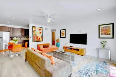 a living room with a couch and a flat screen tv at Orange Dream on the Water in Fort Lauderdale