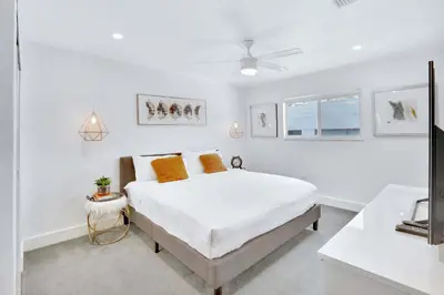 a white bedroom with a bed and a window at Orange Dream in the Sky in Fort Lauderdale