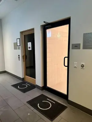 a hallway with two doors and mats in a building at Art-filled Loft 180 Views, Rooftop Pool, Parking in Miami