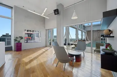 a living room with chairs and a table in a building at Art-filled Loft 180 Views, Rooftop Pool, Parking in Miami