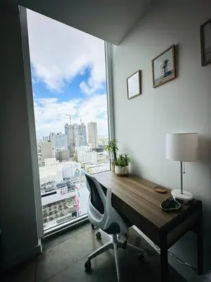 a desk in a room with a large window at Art-filled Loft 180 Views, Rooftop Pool, Parking in Miami