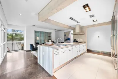 a kitchen with white cabinets and a sink at Luxury Miami Villa with Large Pool & BBQ, Perfect Getaway! in Miami