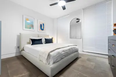 a white bedroom with a bed and a ceiling fan at Luxury Miami Villa with Large Pool & BBQ, Perfect Getaway! in Miami