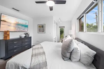 a white bedroom with a bed and a large window at Luxury Miami Villa with Large Pool & BBQ, Perfect Getaway! in Miami