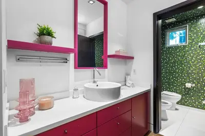 a bathroom with a sink and a toilet and a mirror at Luxury Miami Villa with Large Pool & BBQ, Perfect Getaway! in Miami