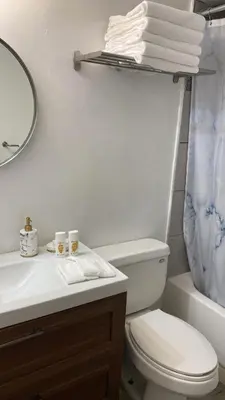 a bathroom with a toilet and a sink and a mirror at Departamento sobre la Playa con vista a la Collins Ave in Sunny Isles Beach
