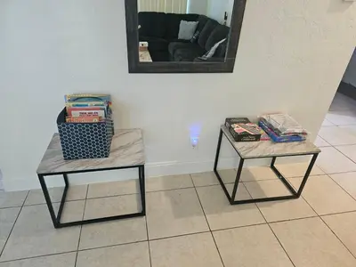 two end tables in a living room with a mirror at Hollywood Happiness in Hollywood
