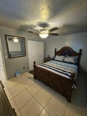 a bedroom with a bed with a ceiling fan at Hollywood Happiness in Hollywood