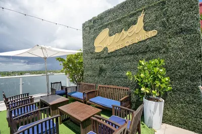 a wall with chairs and tables on a patio at Splendid apartment for 4 pax partial view of the beach in Hollywood M in Hollywood