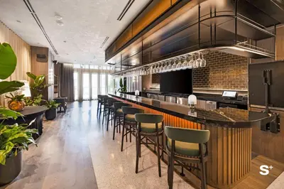 a bar in a restaurant with a bunch of stools at Modern DTW Miami Escape with Water Views in Miami