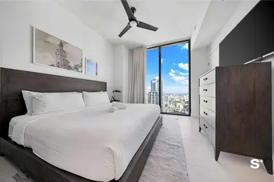 a bedroom with a large bed and a large window at Luxury 1-BD with Breathtaking Downtown Views in Miami