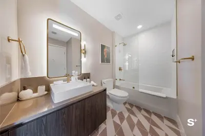 a bathroom with a sink and a toilet and a mirror at Luxury 1-BD with Breathtaking Downtown Views in Miami