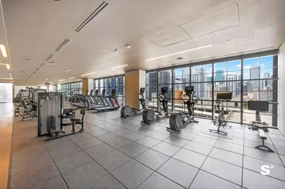 a gym with cardio equipment and a large window at Luxury 1-BD with Breathtaking Downtown Views in Miami