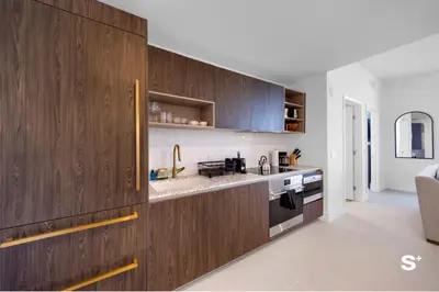 a kitchen with dark wood cabinets and a sink at Luxury 1-BD with Breathtaking Downtown Views in Miami