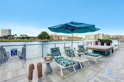 a patio with a table and chairs and an umbrella at Miami Escape Views & Amenities in Hollywood