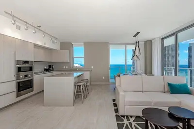 a kitchen and living room with a couch and a table at Miami Escape Views & Amenities in Hollywood