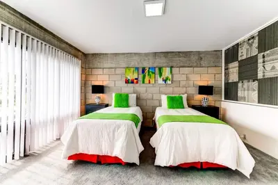 two beds in a room with green and white at Entire townhouse Ft Lauderdale in Fort Lauderdale