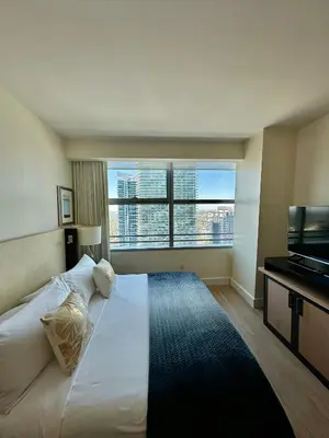 a bedroom with a large white bed with a large window at Brickell AKA 32th Free Parking by Palermo Home Miami in Miami