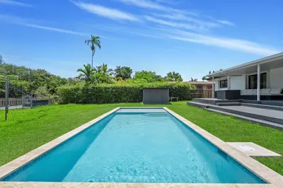 a swimming pool in the yard of a house at Luxury Miami Waterfront Retreat with Private Dock in Golden Glades